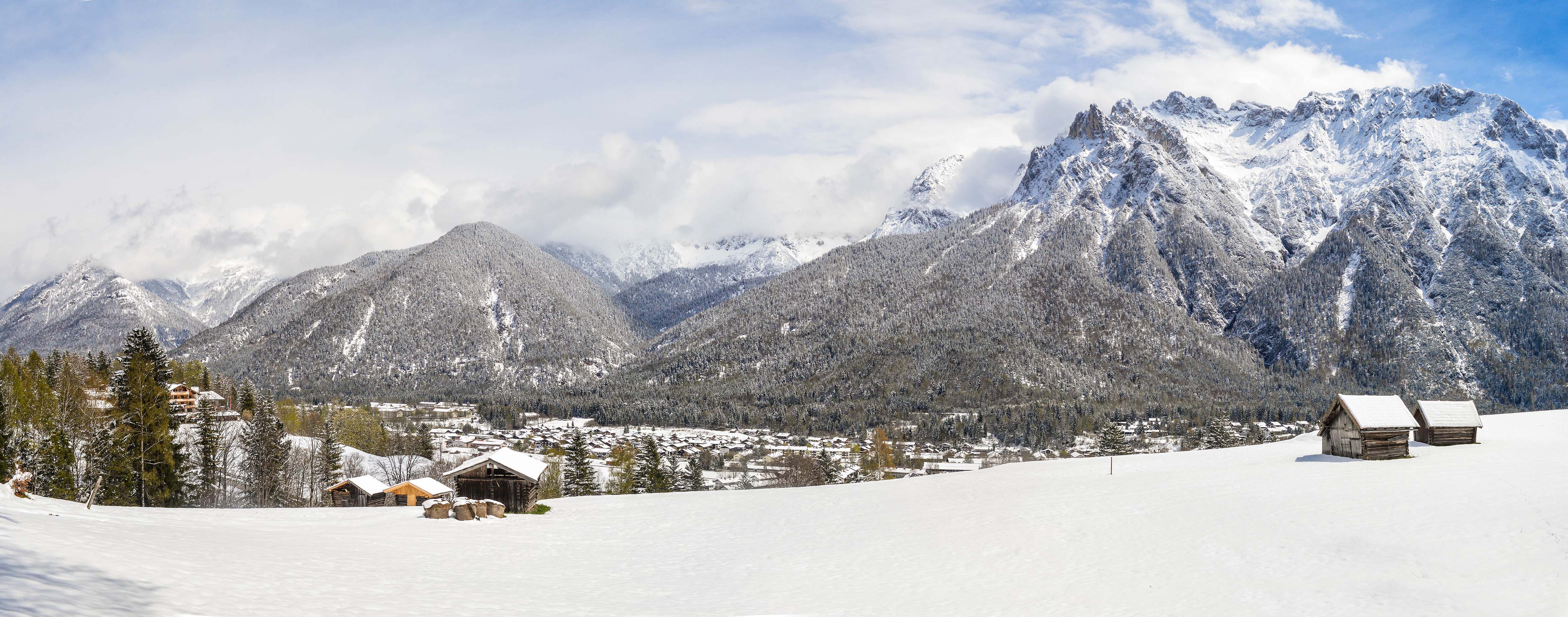 Breathtaking view of mountains and valleys in Furna, Switzerland with a partly cloudy sky.