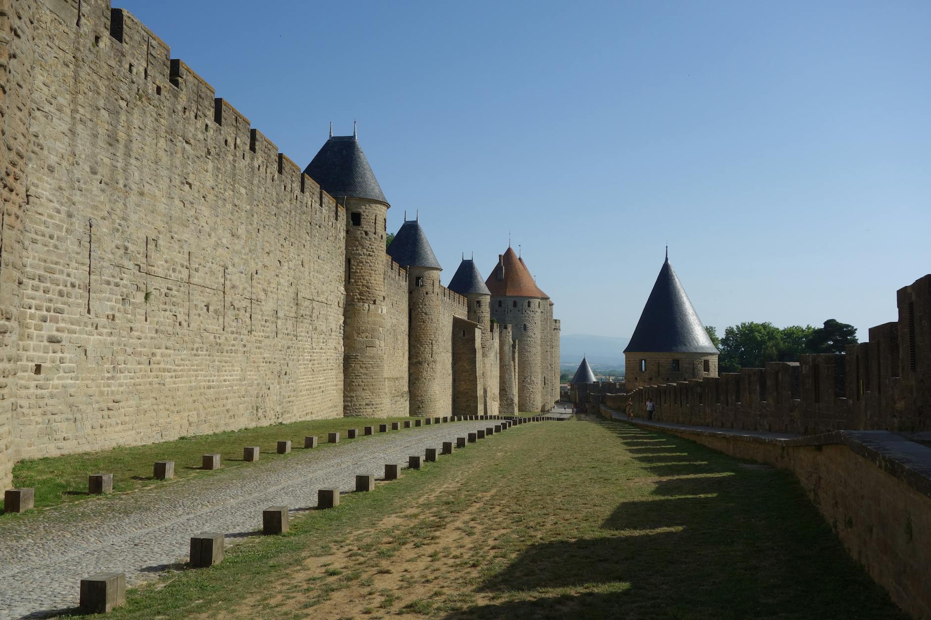 Explore the ancient fortified walls of Carcassonne in France, showcasing medieval architecture and historic charm.